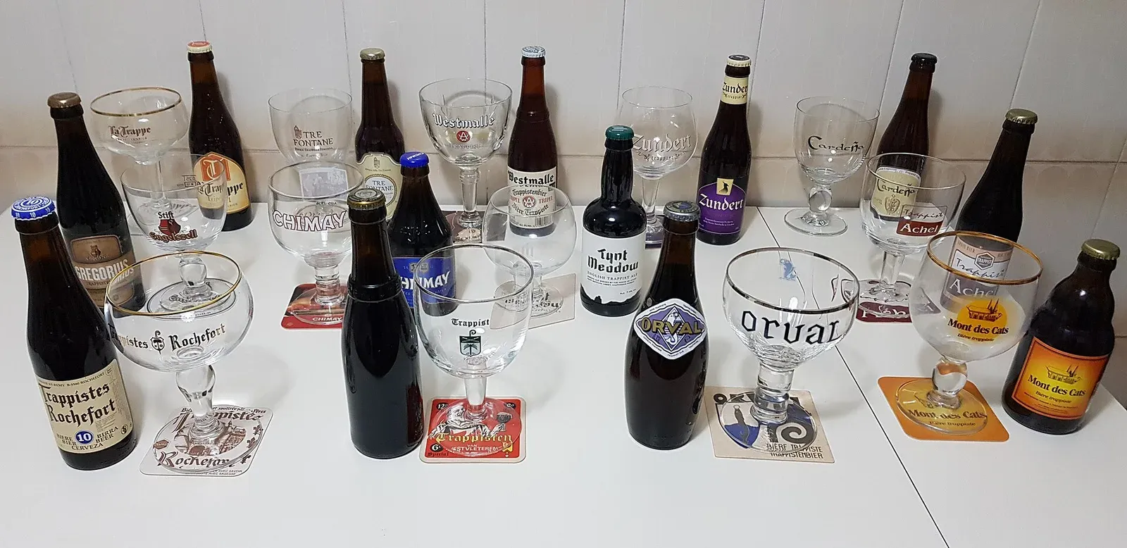 Bottles and glasses from Trappist breweries, among them Westmalle, Chimay, Rochefort, Orval and Westvleteren